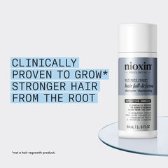 Hand holding NIOXIN 50mL bottle to show compact travel-friendly size benefit