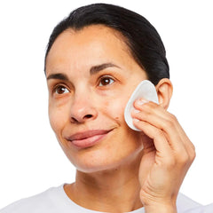No7 bottle being applied to a cotton pad to remove makeup and refresh skin
