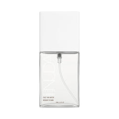 Nuda CloudMist bottle close-up showing lightweight clear self-tanner for a natural glow