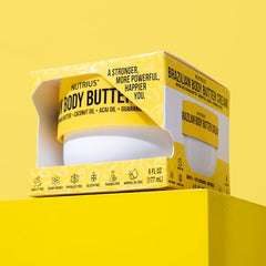 Nutrius Brazilian Body Butter cream jar closeup reveals creamy texture for fast absorption.
