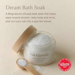 Oak Essentials Dream Bath Soak bottle pouring into warm bath for relaxation.