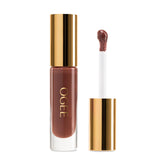 Ogee Beyond Clean Lip Gloss foxglove tube closeup shows rich rosy brown color with high shine.
