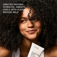 Olaplex Nº.10 being applied to curls to enhance definition and detangle