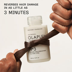 100 mL Olaplex No.3 bottle beside tape measure indicating compact travel-friendly size