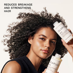 hand pouring Olaplex Nº.4 to show creamy consistency and control benefit