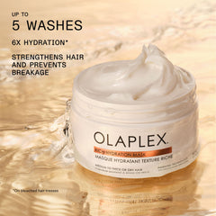 Olaplex being applied to damp hair demonstrating frizz control