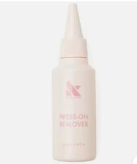 Olive & June Press-On Nail Remover Kit caps and wooden cuticle pusher shown for gentle, efficient removal.