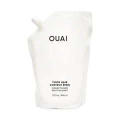 OUAI Thick Hair Conditioner refill bottle closeup highlighting hydrating formula for strands