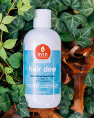 Oyin Handmade Hair Dew on fingertips illustrating hydrating leave-in prep
