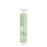 Paul Mitchell Clean Beauty anti-frizz shampoo bottle pour promotes frizz control for textured hair.