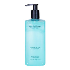 Pecksniff's Hand Wash sandalwood vanilla bottle on sink shelf offers luxurious fragrance for daily pampering.