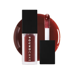 POUND CAKE Cake Theory lip oil bottle shows violet-brown tint for balanced lip tone