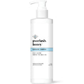PSORIASIS HONEY Renewing Shampoo bottle closeup highlights hydrating scalp care for dry flakes.
