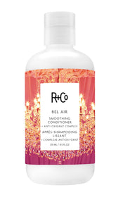 R+Co BEL AIR smoothing conditioner bottle close-up for sleek, frizz-free styling.