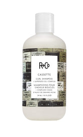 R+Co CASSETTE Curl Shampoo bottle demonstrates gentle cleansing for defined, soft curls.
