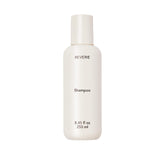 REVERIE Natural Balancing Shampoo bottle closeup shows sulfate-free cleansing for color-treated hair.