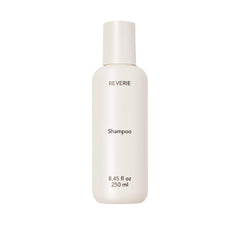 REVERIE Natural Balancing Shampoo bottle closeup shows sulfate-free cleansing for color-treated hair.