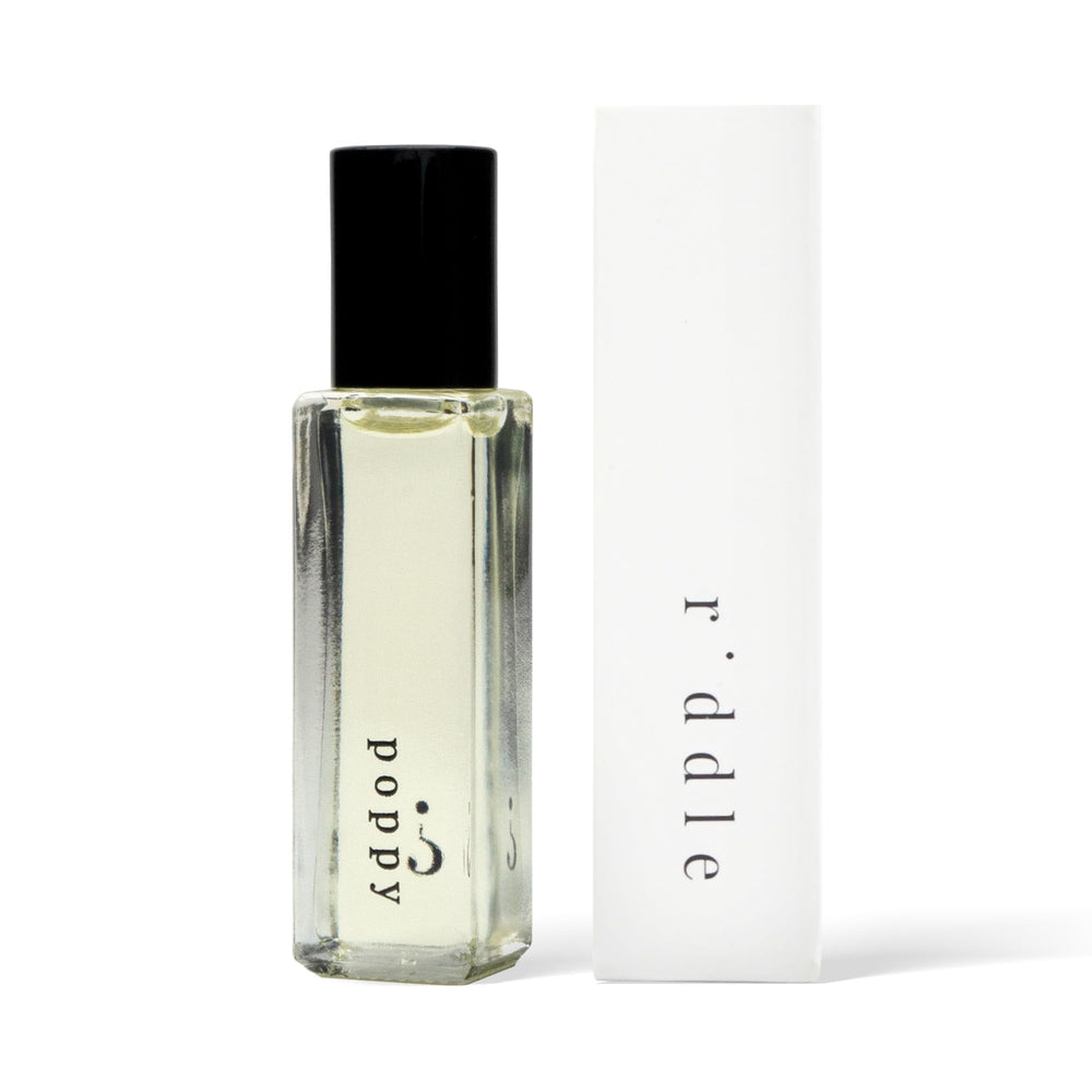 Riddle Oil Poppy roll-on bottle closeup shows premium citrus-floral scent for everyday wear