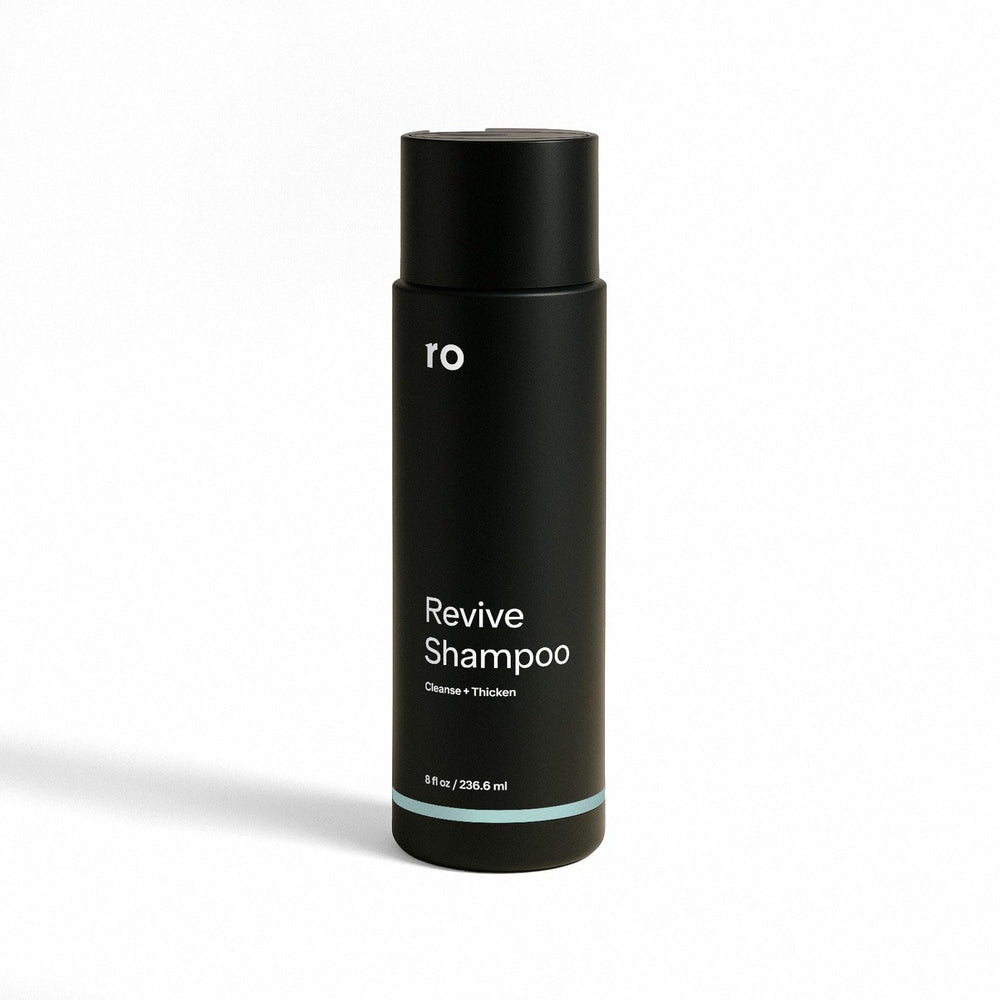 ROMAN Ro Men's Revive Shampoo bottle with minty cleanse for a refreshed scalp and fuller appearance.