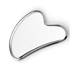 Sacheu Gua Sha face tool close-up demonstrates cooling stainless steel for lymphatic drainage.