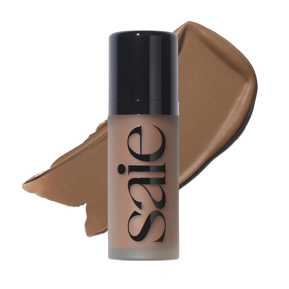 Saie Dew Bronze bottle closeup shows skin-care infused formula for a sun-kissed glow.