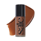 Saie Dew Bronze bottle closeup highlighting hydrating bronzer for sun-kissed glow