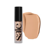 Saie Slip Tint concealer bottle closeup shows lightweight medium coverage for an undetectable blemish-concealing look.