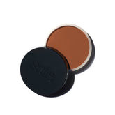 Saie Sun Melt cream bronzer jar close-up reveals velvety texture for natural warmth.