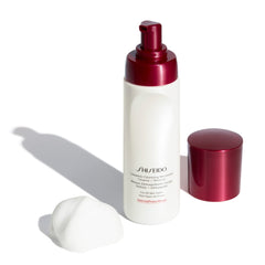Shiseido Complete Cleansing Microfoam foam in hand; gentle purification for all skin types.
