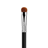 Sigma Beauty E55 eye shading brush applying cream eyeshadow for an even base.