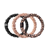 SLIP skinny scrunchies in black for gentle, crease-free wear and hair protection.