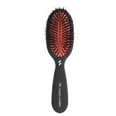 Spornette small luxury cushion oval brush in use for travel detangling all hair types
