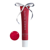 Summer Fridays Cherry lip balm application shows instant hydration.