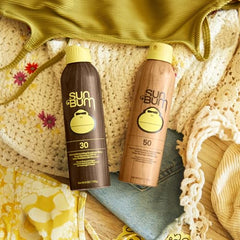Sun Bum Original SPF30/50 spray mist application demonstrates easy outdoor reapplication.