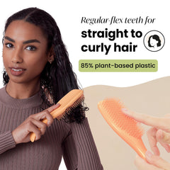 Tangle Teezer detangler brush in hand for versatile wet and dry detangling.