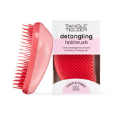 The Tangle Teezer Original Detangler Pink Punch shown on hair section for smooth detangling.