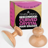 Temple Spring Curved Crystal Hair Remover Stone in palm grip for quick, painless removal.