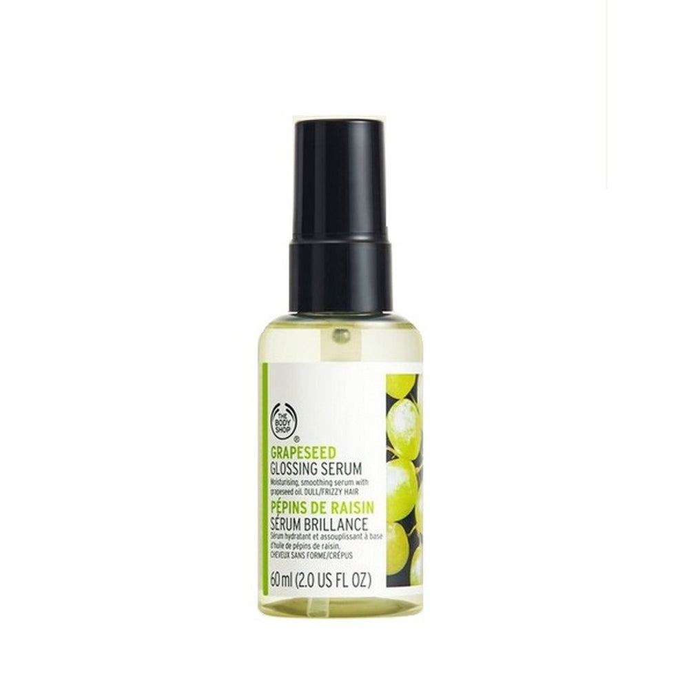 The Body Shop Grapeseed Glossing Serum bottle on a vanity for gloss and styling.