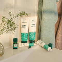 The Body Shop Tea Tree cleanser pump dispensing with clean hands demonstrating daily oil control.