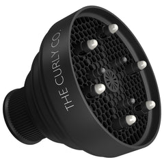 The Curly Co collapsible hair diffuser folded for ultra-portable storage after travel.