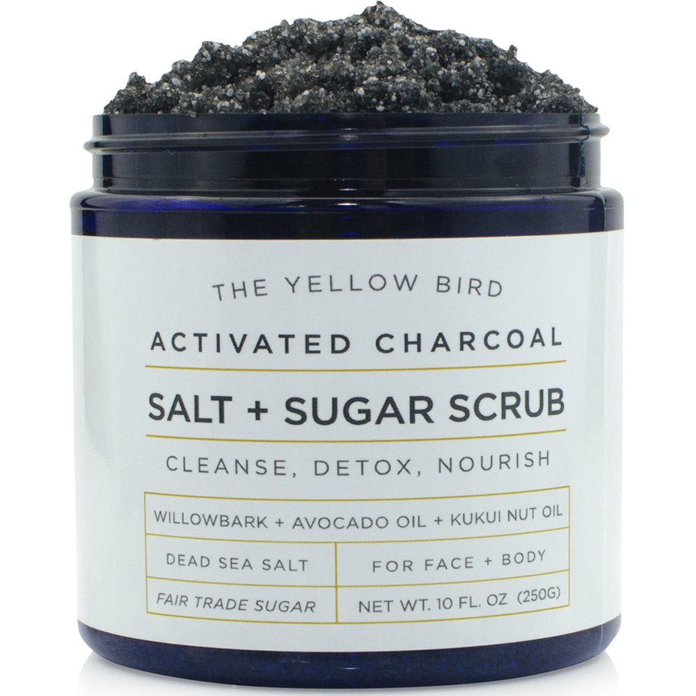 The Yellow Bird activated charcoal face scrub packaging highlights USA-made cleansing.