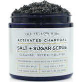 The Yellow Bird activated charcoal face scrub packaging highlights USA-made cleansing.