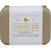 The Yellow Bird solid bar shampoo closeup shows grapefruit, rosemary and lavender aroma.