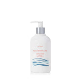Thymes Aqua Coralline hand lotion silver pump front view highlights glossy packaging and moisturizing action