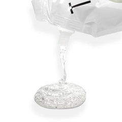 TKB Lip Gloss Base clear bottle close-up demonstrating smooth, heat-free blending for custom shades