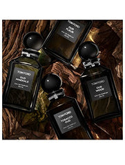 Tom Ford Oud Wood bottle-cap close-up signals premium scent for evening wear.