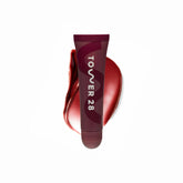 Tower 28 LipSoftie balm applying on lips for instant hydration