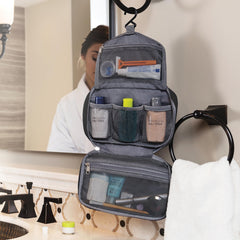 Travelon compact hanging toiletry kit open reveals mesh pouches and top pocket.