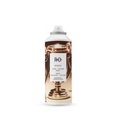 R+Co Trophy Shine Texture Spray bottle ready for use, showing sleek design and texture.