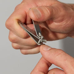Tweezerman Essential Grooming Kit fingernail-clipper-curved-blade demonstrates precise nail trimming.
